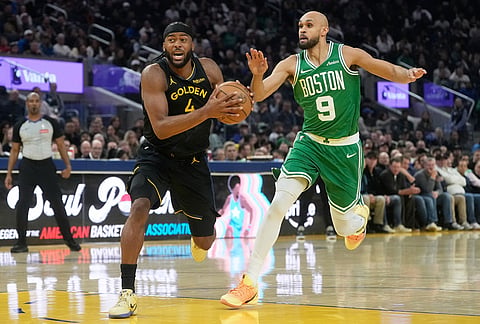 Golden State Warriors guard Moses Moody (4) drives to the basket against Boston Celtics guard Derrick White (9) during the first half of an NBA basketball game in San Francisco.