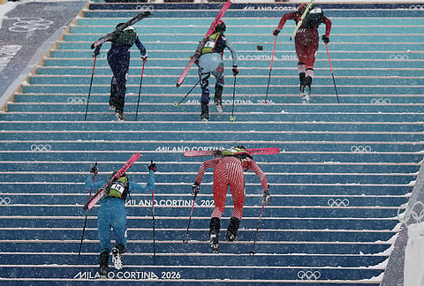 Athletes, including Italy's Alba de Silvestro, bottom left, compete during a ski mountaineering women's sprint heat, at the 2026 Winter Olympics, in Bormio, Italy.