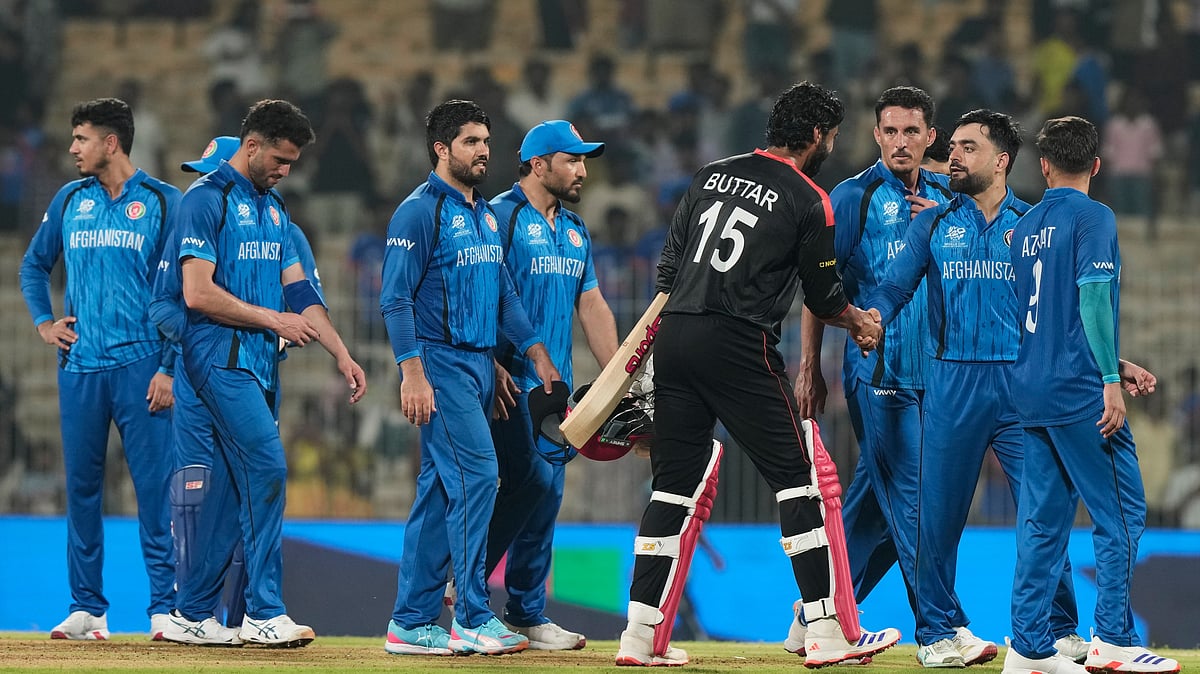 (AP Photo/Mahesh Kumar A.) : Afghanistan's captain Rashid Khan, second right, shakes hands with Canada's Jaskarandeep Buttar after winning the T20 World Cup cricket match between Afghanistan and Canada in Chennai, India, Thursday, Feb. 19, 2026.