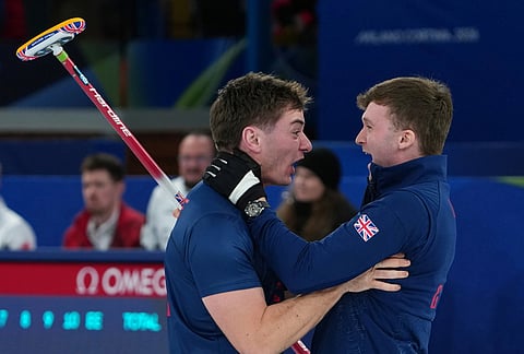 Britain's Grant Hardie and Bruce Mouat react after beating Switzerland in a men's curling semifinal match at the 2026 Winter Olympics, in Cortina d'Ampezzo, Italy.