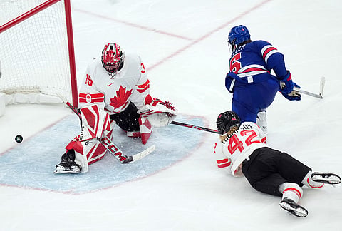 United States' Megan Keller (5) scores the winning goal against Canada goalkeeper Ann-Renee Desbiens (35) during the overtime period of the women's ice hockey gold medal game at the 2026 Winter Olympics, in Milan, Italy.