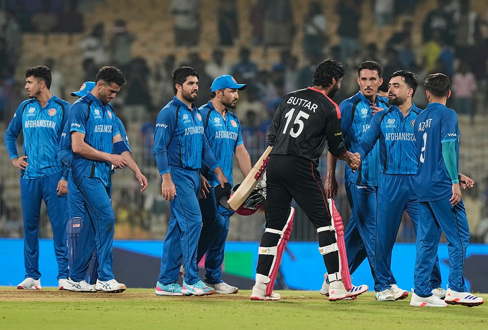 | Photo: AP/Mahesh Kumar A. : Afghanistan's captain Rashid Khan, second right, shakes hands with Canada's Jaskarandeep Buttar after winning the T20 World Cup cricket match between Afghanistan and Canada in Chennai.