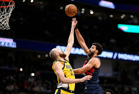 Washington Wizards forward Anthony Gill, right, goes to the basket against Indiana Pacers center Jay Huff (32) during the second half of an NBA basketball game, in Washington.