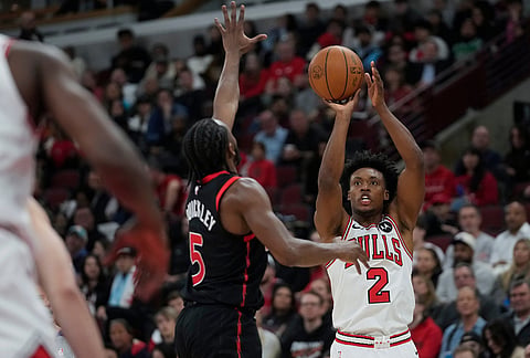 Chicago Bulls guard Collin Sexton (2) prepares to shoot a 3-point basket as Toronto Raptors guard Immanuel Quickley (5) defends during the first half of an NBA basketball game in Chicago.
