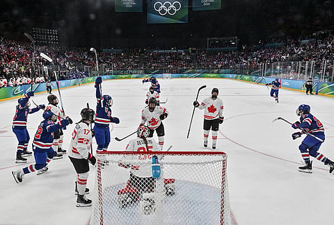 Players of the United States celebrate scoring their team's first goal during the women's ice hockey gold medal game between the United States and Canada at the 2026 Winter Olympics, in Milan, Italy.