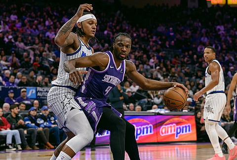 Sacramento Kings forward Precious Achiuwa (9) is guarded by Orlando Magic forward Paolo Banchero (5) during the second half of an NBA basketball game in Sacramento, California.