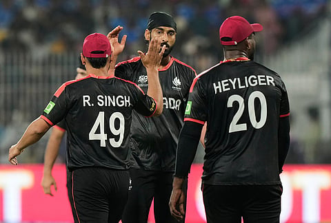 Canada's Jaskarandeep Buttar, center, celebrates with teammates the wicket of Afghanistan's Sediqullah Atal during the T20 World Cup cricket match between Afghanistan and Canada in Chennai.