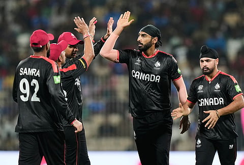 Canada's Jaskarandeep Buttar, second right, celebrates with teammates the wicket of Afghanistan's Rahmanullah Gurbaz during the T20 World Cup cricket match between Afghanistan and Canada in Chennai.