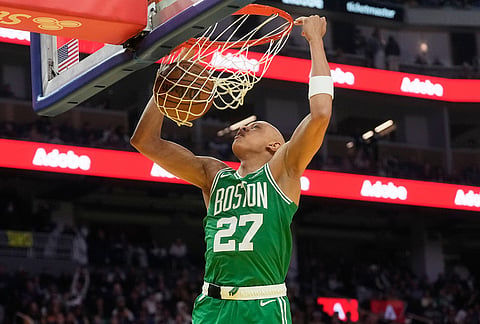 Boston Celtics guard Jordan Walsh (27) dunks against the Golden State Warriors during the first half of an NBA basketball game in San Francisco.