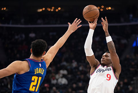 Los Angeles Clippers guard Bennedict Mathurin (9) shoots over Denver Nuggets forward Spencer Jones (21) during the first half of an NBA basketball game in Inglewood, California.