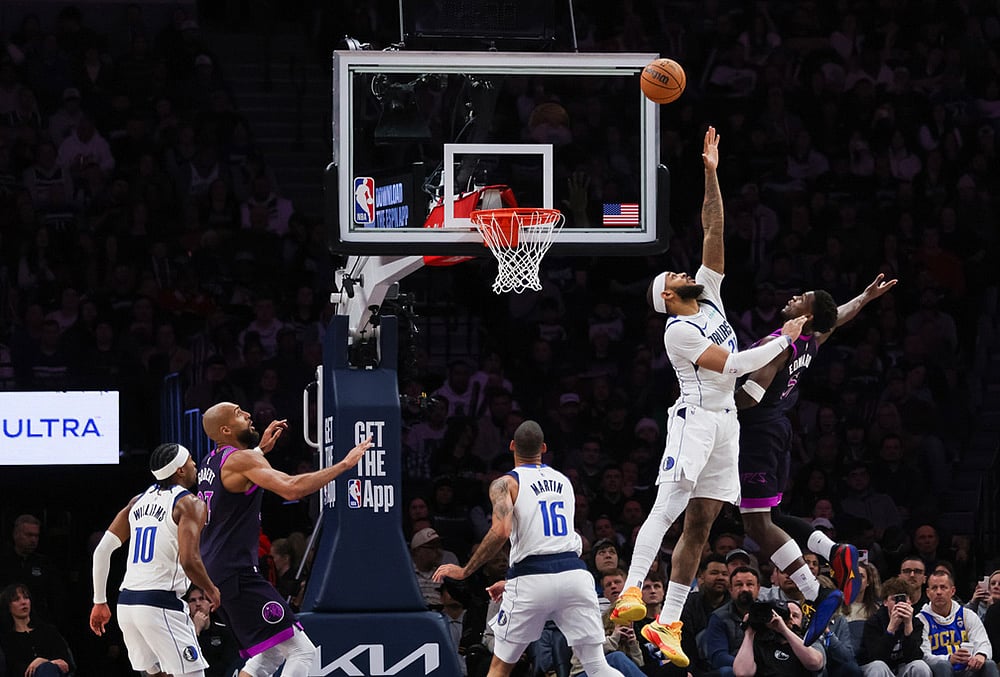 | Photo: AP/Lily Dozier : Dallas Mavericks' Daniel Gafford, second from right, leaps to block a shot by Minnesota Timberwolves' Anthony Edwards, right, during the second half of an NBA basketball game in Minneapolis. 