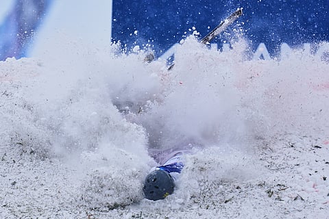Ukraine's Maksym Kuznietsov crashes during the men's freestyle skiing aerials qualifications at the 2026 Winter Olympics, in Livigno, Italy.