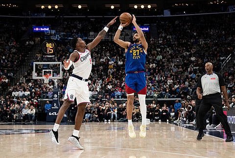 Denver Nuggets guard Jamal Murray (27) shoots over Los Angeles Clippers guard Bennedict Mathurin (9) during the second half of an NBA basketball game in Inglewood, California.