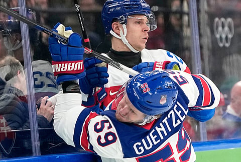 Slovakia's Adam Liska (23) challenges with United States' Jake Guentzel (59) during a men's ice hockey semifinal game between the United States and Slovakia at the 2026 Winter Olympics, in Milan, Italy.