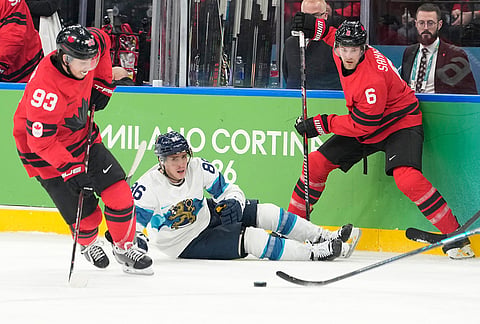 Finland's Teuvo Teravainen (86) challenges with Canada's Travis Sanheim (6) and Canada's Mitch Marner (93) during a men's ice hockey semifinal game between Canada and Finland at the 2026 Winter Olympics, in Milan, Italy.