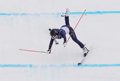 Japan's Makiko Arai (27) crashes during the women's ski cross qualifications at the 2026 Winter Olympics, in Livigno, Italy.