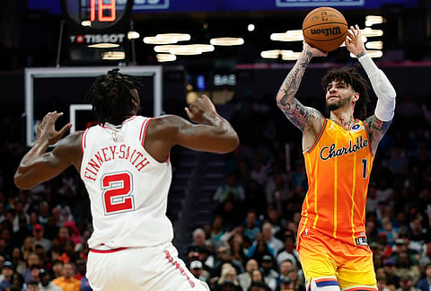 Charlotte Hornets guard LaMelo Ball (1) looks to shoot against Houston Rockets forward Dorian Finney-Smith (2) during the second half of an NBA basketball game in Charlotte, North Carolina.