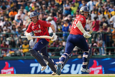England's Phil Salt, left, and Sam Curran run between the wickets during the T20 World Cup cricket match between Sri Lanka and England in Pallekele, Sri Lanka.