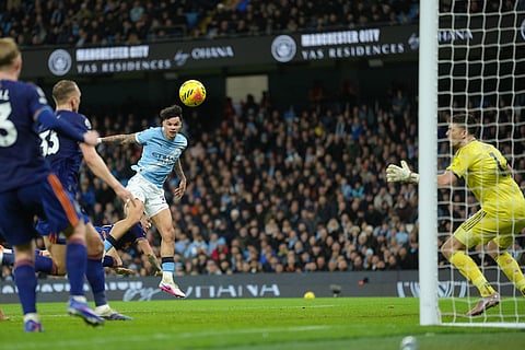 Manchester City's Nico O'Reilly scores during the English Premier League soccer match between Manchetser City and Newcastle in Manchester, England.