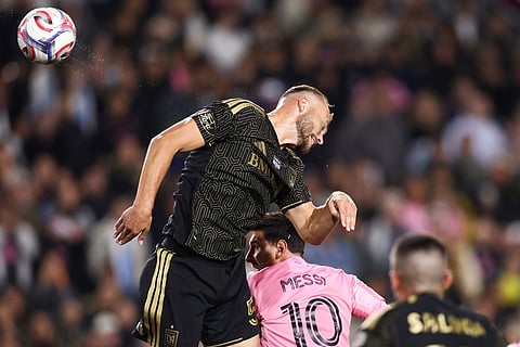 Inter Miami forward Lionel Messi (10) heads the ball against Los Angeles FC defender Ryan Porteous, left, as defender Sergi Palencia (14) watches during the second half of an MLS soccer match in Los Angeles, Calif.