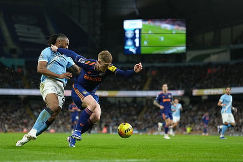 Manchester City's Antoine Semenyo, left, and and Newcastle's Lewis Hall fight for the ball during the English Premier League soccer match between Manchetser City and Newcastle in Manchester, England.