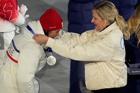 IOC President Kirsty Coventry, right, awards Heidi Weng, of Norway, the silver medal at medal ceremony for the cross country skiing women's 50km mass start classic during the closing ceremony of the 2026 Winter Olympics, in Verona, Italy, Sunday, Feb. 22, 2026. 