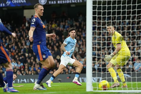 Manchester City's Nico O'Reilly scores during the English Premier League soccer match between Manchetser City and Newcastle in Manchester, England.
