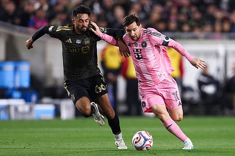 Inter Miami forward Lionel Messi (10) dribbles the ball against Los Angeles FC midfielder Mathieu Choinière, left, during the second half of an MLS soccer match in Los Angeles, Calif.