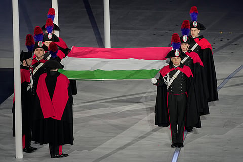 Carabinieri police officers carry an Italian flag during the closing ceremony of the 2026 Winter Olympics, in Verona, Italy, Sunday, Feb. 22, 2026.