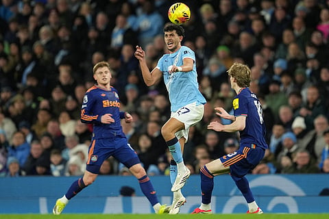 Manchester City's Matheus Nunes heads the ball in front of Newcastle's Anthony Gordon during the English Premier League soccer match between Manchetser City and Newcastle in Manchester, England.