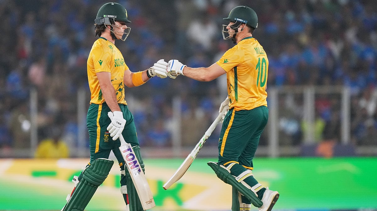 (AP Photo/Ajit Solanki) : South Africa's Dewald Brevis, left, and batting partner David Miller touch gloves during the T20 World Cup cricket match between India and South Africa in Ahmedabad, India, Sunday, Feb. 22, 2026
