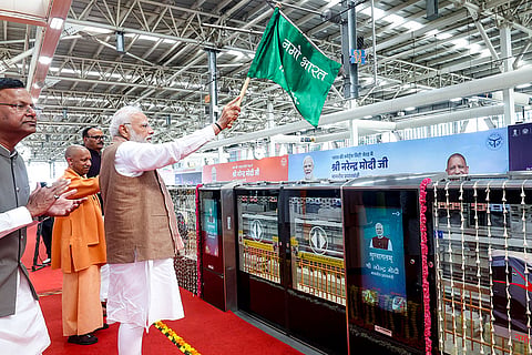 In this image posted on Feb. 22, 2026, Prime Minister Narendra Modi flags off the Meerut Metro and Namo Bharat train at a ceremonial launch at Shatabdi Nagar Namo Bharat Station, in Meerut. Uttar Pradesh Chief Minister Yogi Adityanath, Deputy Chief Minister Brajesh Pathak and BJP State President Pankaj Chaudhary are also seen.