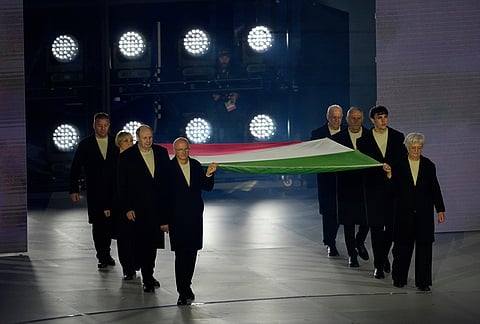 Flagbearers carry the Italian flag during the closing ceremony of the 2026 Winter Olympics, in Verona, Italy.
