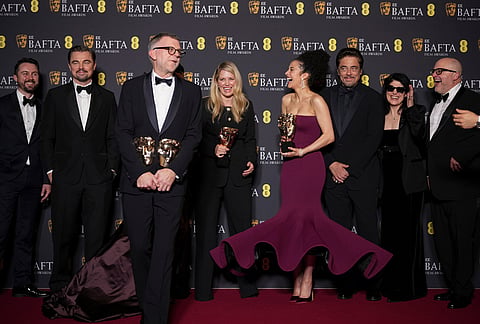 Andy Jurgensen, from left, Leonardo DiCaprio, Teyana Taylor, Paul Thomas Anderson, Sara Murphy, Chase Infiniti, Benicio Del Toro, Cassandra Kulukundis, and Michael Bauman pose with the awards for best director, cinematography, and adapted screenplay for 'One Battle After Another' at the 79th British Academy Film Awards, BAFTA's, in London.
