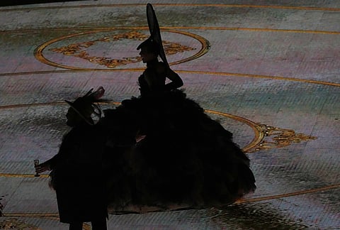 Artists are silhouetted as they perform during the closing ceremony of the 2026 Winter Olympics, in Verona, Italy.