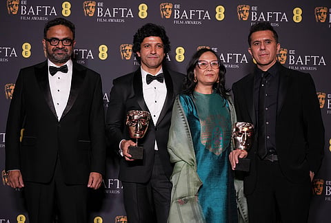 Alan McAlex, from left, Farhan Akhtar, Lakshmipriya Devi, and Ritesh Sidhwani pose with the award for children's & family film for 'Boong' at the 79th British Academy Film Awards, BAFTA's, in London.