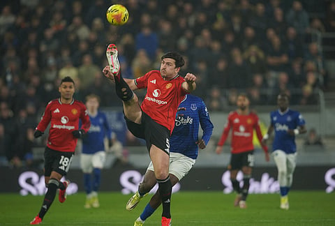 Manchester United's Harry Maguire clears the ball during the Premier League soccer match between Manchester United and Everton in Liverpool, England.