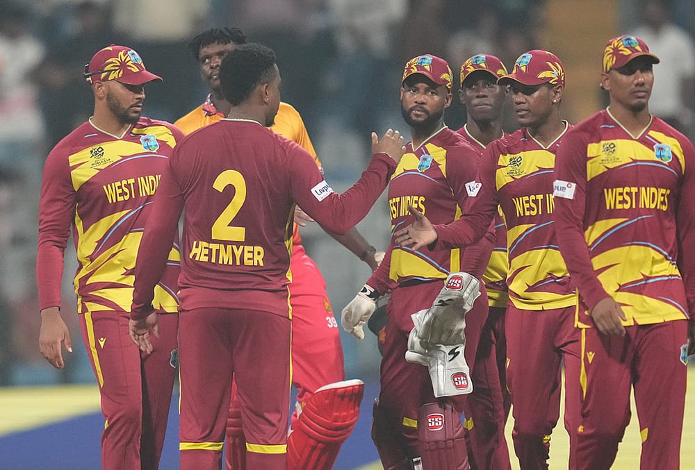| Photo: AP/Rafiq Maqbool : West Indies' Shimron Hetmyer, second from left, celebrates with teammates after their win against Zimbabwe during the T20 World Cup cricket match in Mumbai.