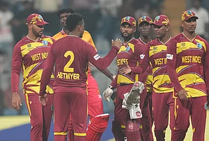 | Photo: AP/Rafiq Maqbool : West Indies' Shimron Hetmyer, second from left, celebrates with teammates after their win against Zimbabwe during the T20 World Cup cricket match in Mumbai.