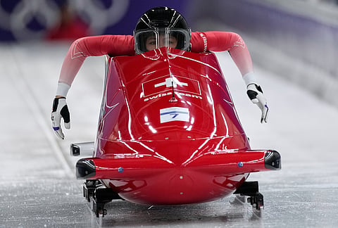 Switzerland's Melanie Hasler, front, and Nadja Pasternack start for a two women bobsled run at the 2026 Winter Olympics, in Cortina d'Ampezzo, Italy, Friday, Feb. 20, 2026.