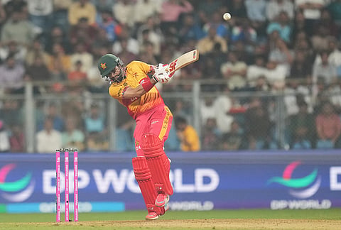Zimbabwe's captain Sikandar Raza hits a six during the T20 World Cup cricket match between Zimbabwe and West Indies in Mumbai.