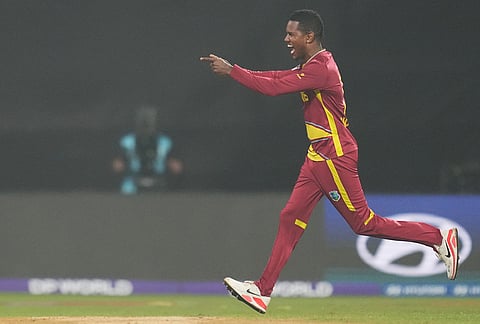 West Indies' Akeal Hosein celebrates the wicket of Zimbabwe's Blessing Muzarabani during the T20 World Cup cricket match between Zimbabwe and West Indies in Mumbai.