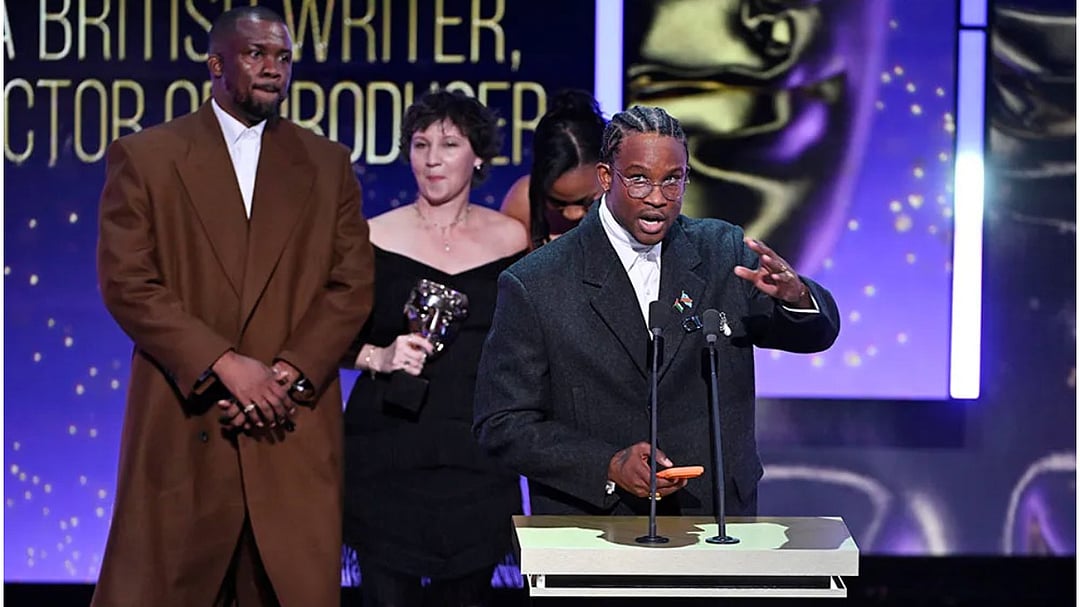 Akinola Davies Jr. accepts the Outstanding Debut by a British Writer, Director or Producer award for My Father’s Shadow