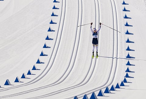 Ebba Andersson, of Sweden, approaches the finish line to win the gold medal in the cross country skiing women's 50km mass start classic at the 2026 Winter Olympics, in Tesero, Italy, Sunday, Feb. 22, 2026. 