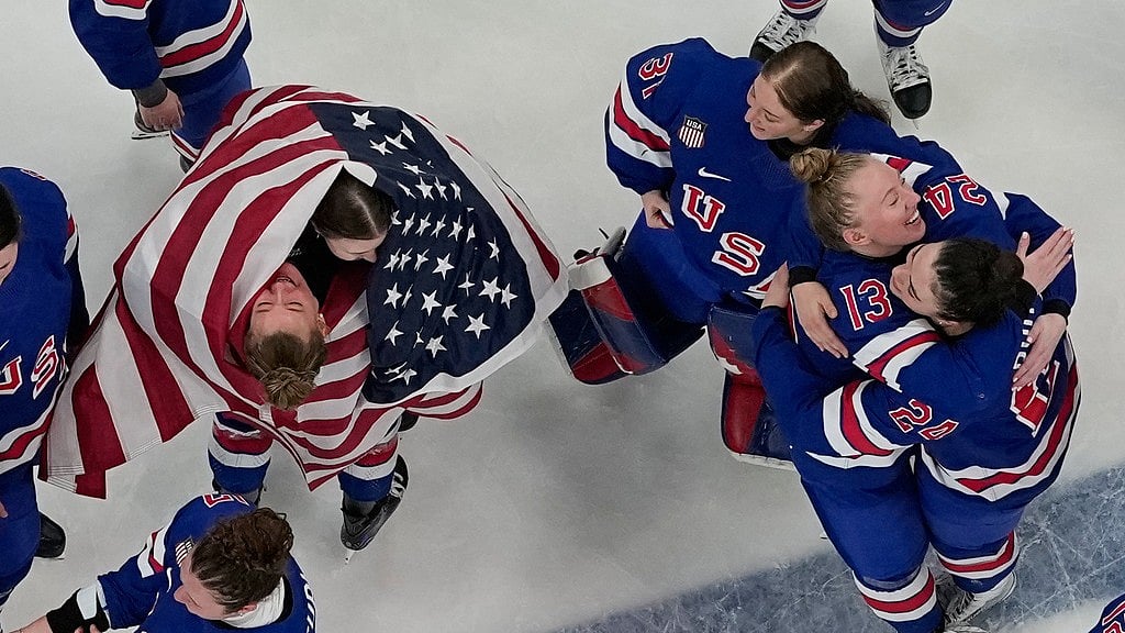 AP : Team United States players celebrate after beating Canada 2-1 in overtime in the women's ice hockey gold medal game at the 2026 Winter Olympics, in Milan.