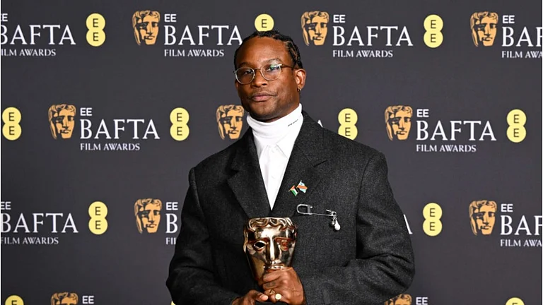 Akinola Davies Jr. accepts the Outstanding Debut by a British Writer, Director or Producer award for My Father’s Shadow - Instagram