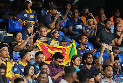 Sri Lankan supporters cheer for their team before the start of the T20 World Cup cricket match between Sri Lanka and New Zealand in Colombo, Sri Lanka.