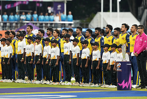 Sri Lankan players stand for their national anthem before the start of the T20 World Cup cricket match between Sri Lanka and New Zealand in Colombo, Sri Lanka.
