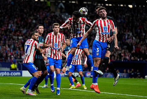 Atletico Madrid's Pablo Barrios, top center, heads the ball during the Champions League play-off second leg soccer match between Atletico Madrid and Club Brugge, in Madrid, Spain.