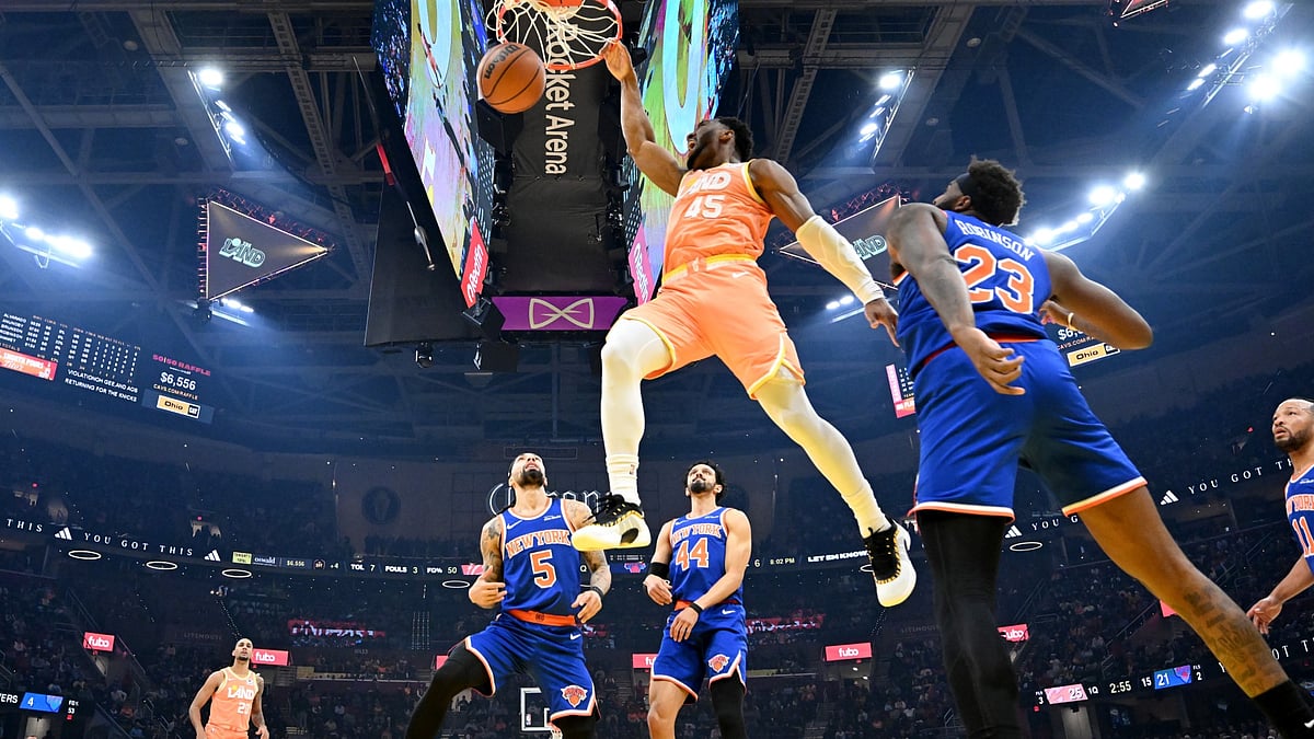 Donovan Mitchell #45 of the Cleveland Cavaliers dunks over Mitchell Robinson #23 of the New York Knicks during the first quarter at Rocket Arena on February 24, 2026 in Cleveland, Ohio. The Cavaliers defeated the Knicks 109-94.